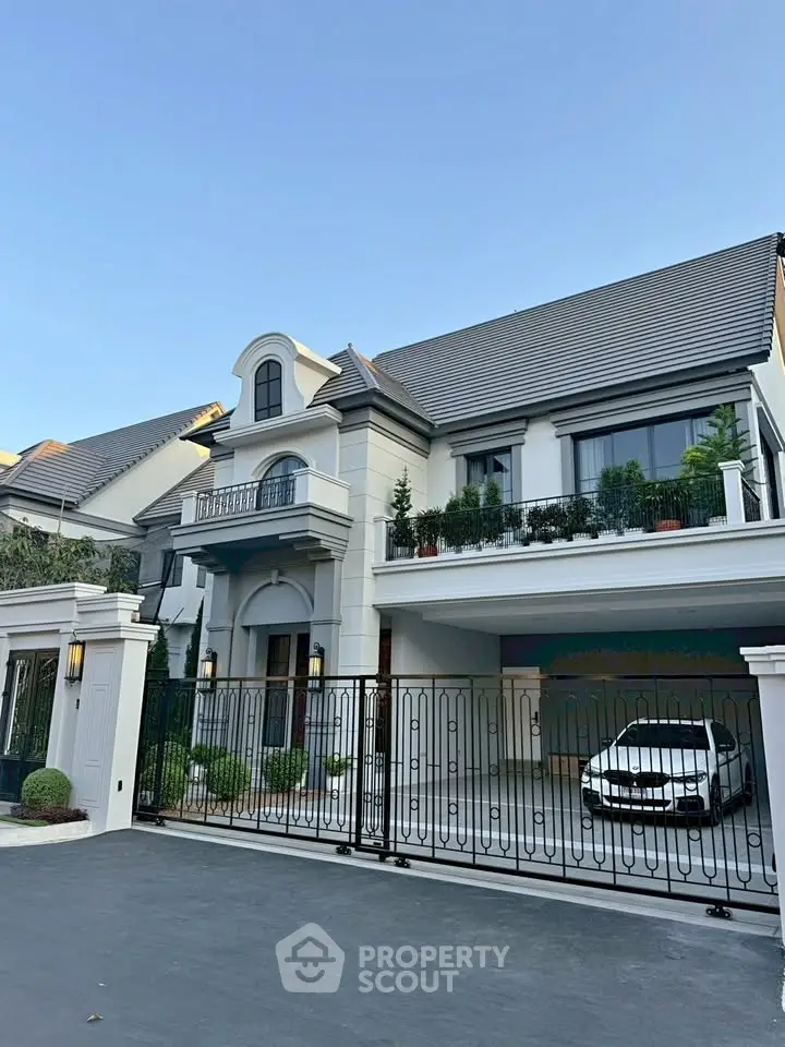 Luxurious modern house with elegant facade and spacious driveway in upscale neighborhood.