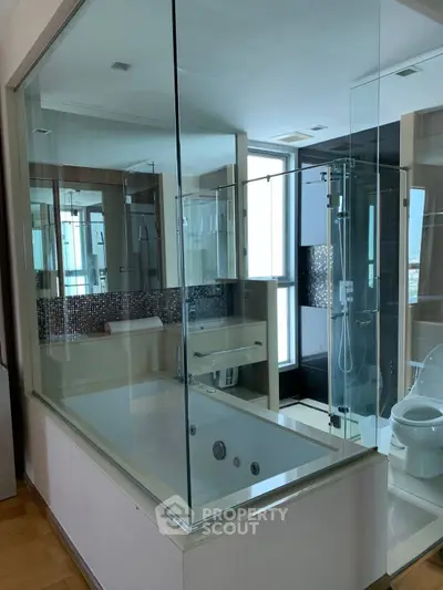 Luxurious modern bathroom with glass shower and bathtub in high-rise apartment