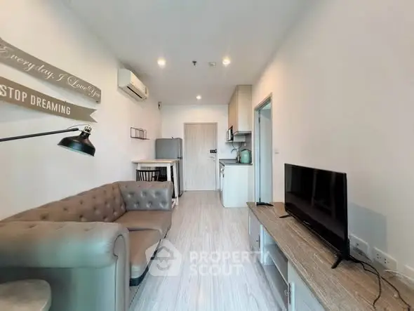 Modern living room with stylish furniture and open kitchen layout in a cozy apartment.