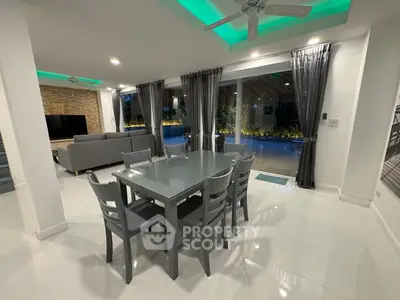 Spacious modern living room with dining area and large windows overlooking garden
