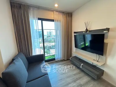 Modern living room with sleek sofa and wall-mounted TV, featuring large window with city view.