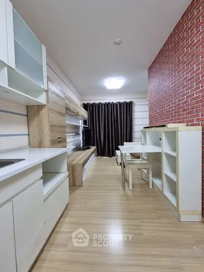 Modern kitchen with open layout and stylish brick accent wall