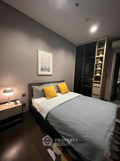 Cozy modern bedroom with stylish decor and ample storage space.