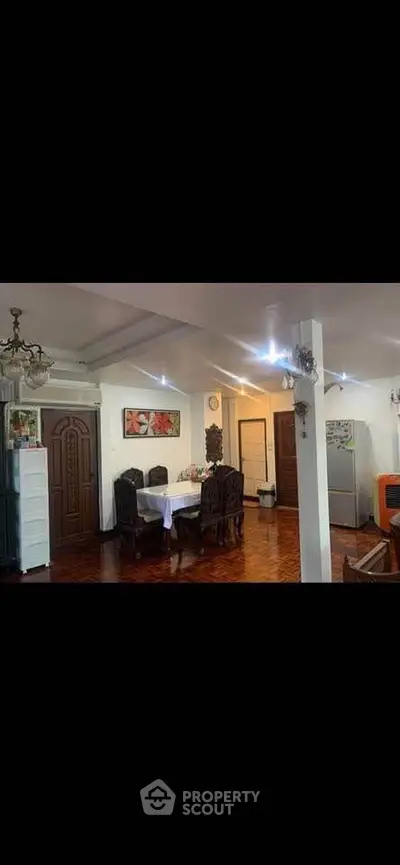 Spacious dining area with elegant wooden furniture and modern appliances