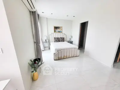 Luxurious bedroom with elegant decor and natural light