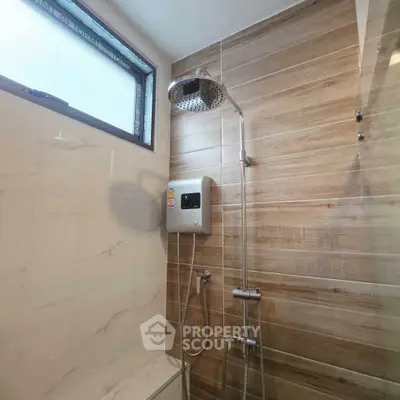 Modern bathroom with stylish shower and wood paneling