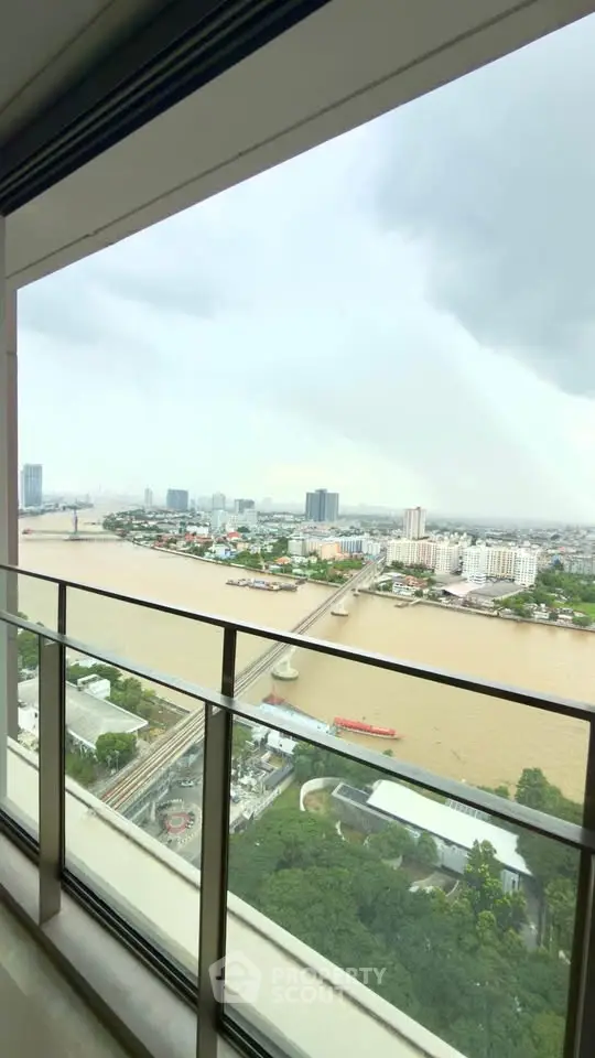 Stunning river view from high-rise balcony with cityscape backdrop