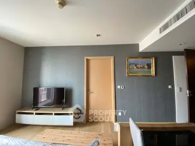 Modern living room with stylish decor and mounted TV, perfect for relaxation and entertainment.
