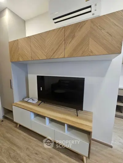 Modern living room with stylish TV unit and air conditioning