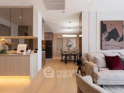Modern open-plan living room with stylish decor and dining area, featuring elegant lighting and contemporary artwork.