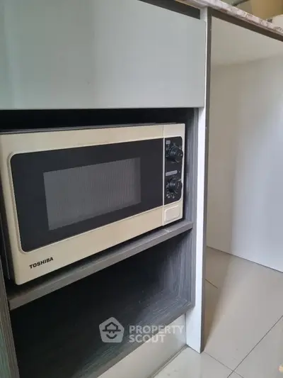Modern kitchen with built-in microwave in sleek cabinetry