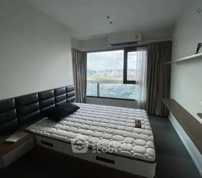 Modern bedroom with large window offering stunning city view, featuring sleek design and ample natural light.