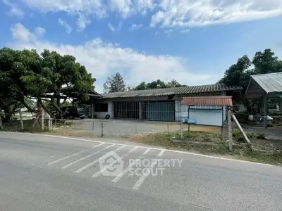 Charming rural property with spacious yard and rustic exterior, ideal for development or agricultural use.
