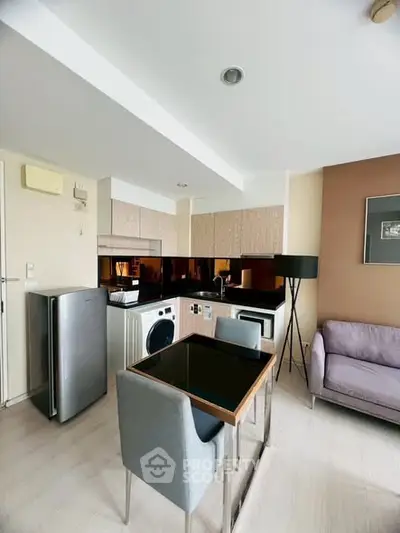 Modern apartment interior with compact kitchen and cozy living area.