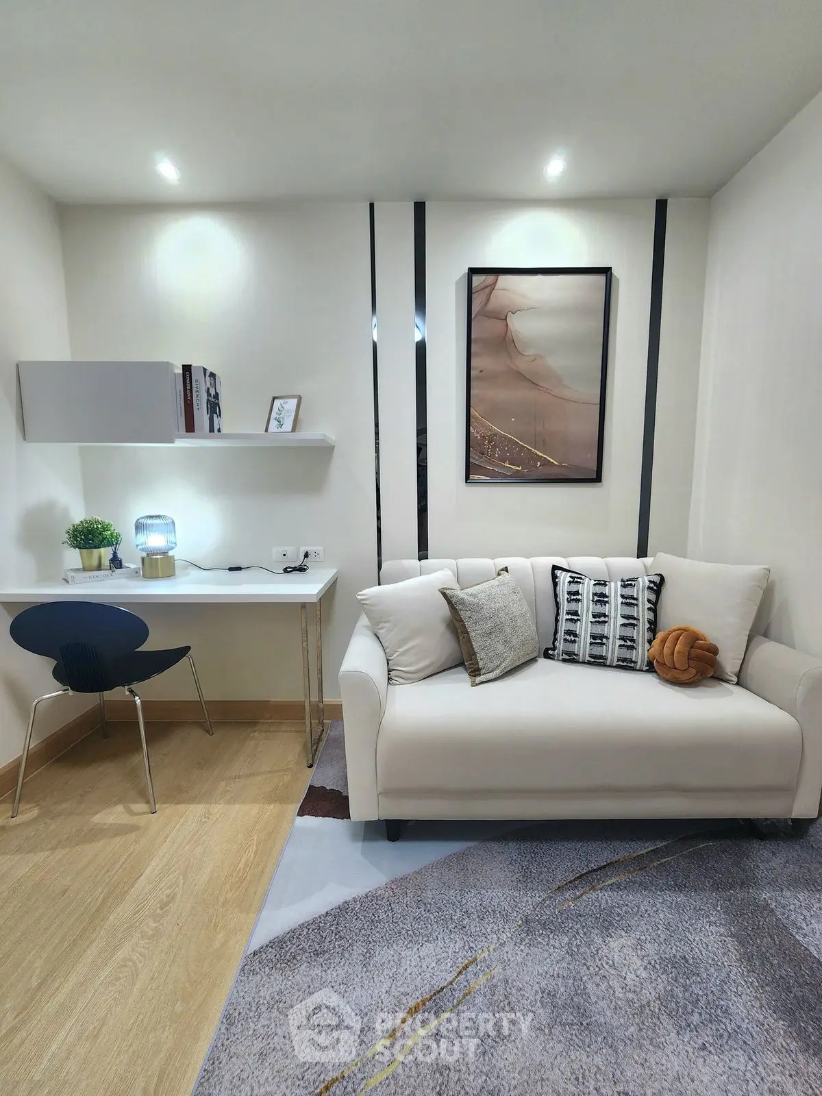 Modern living room with stylish decor and cozy seating area, perfect for relaxation and work-from-home setup.