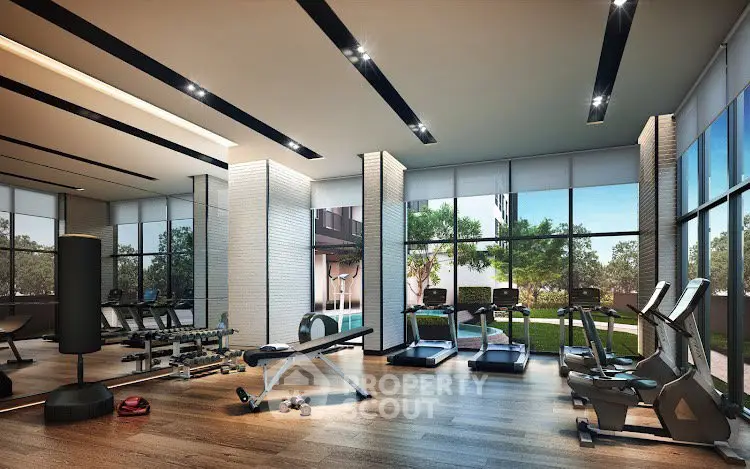 Modern gym with state-of-the-art equipment and large windows offering garden views.