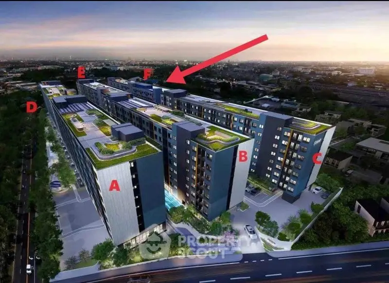 Modern apartment complex with rooftop gardens and city view at sunset.