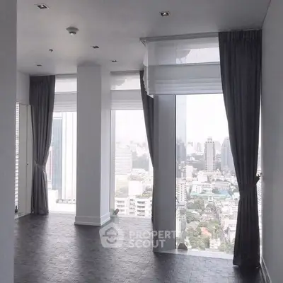 Spacious corner unit with floor-to-ceiling windows offering stunning city views.
