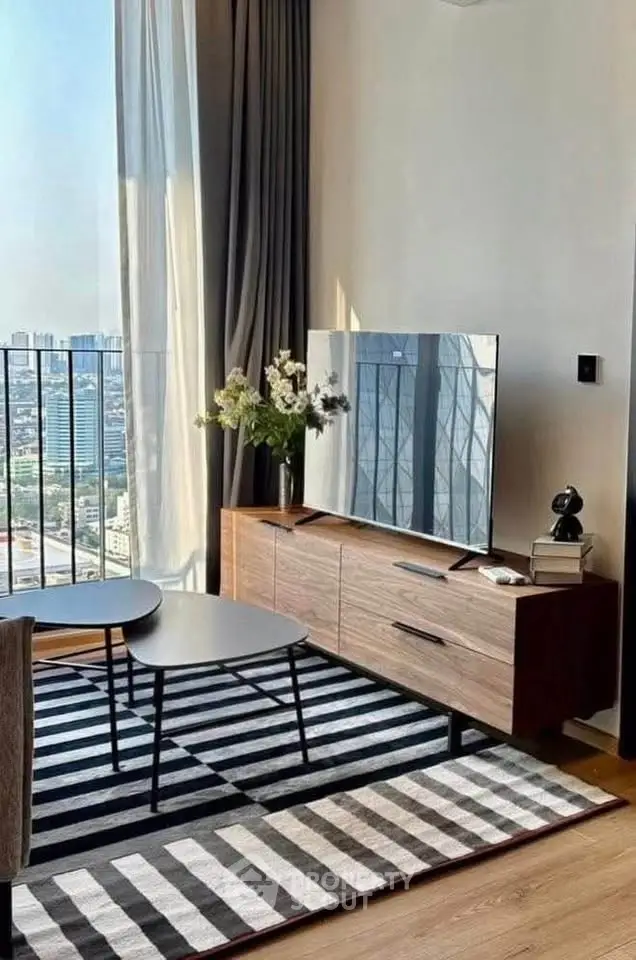Modern living room with city view, stylish furniture, and large windows for natural light.