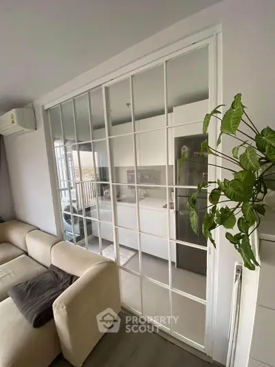 Modern living room with sliding glass doors and cozy beige sofa