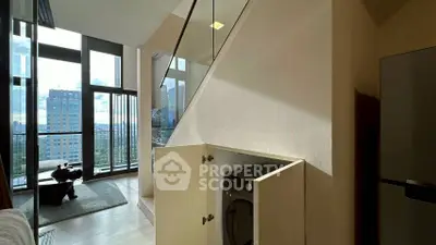 Modern apartment with open layout, featuring a hidden washing machine and stunning city view.