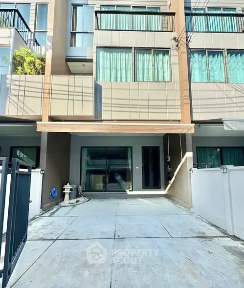 Modern townhouse exterior with spacious driveway and sleek design