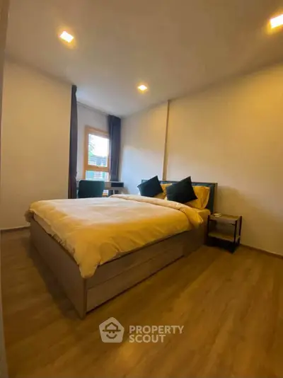 Cozy bedroom with wooden flooring and modern furnishings, perfect for relaxation and comfort.