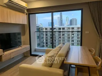 Modern living room with city view, featuring sleek furniture and large windows.
