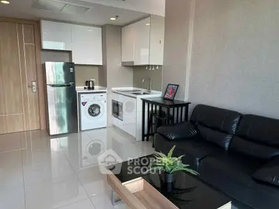 Modern studio apartment with sleek kitchen and cozy living area