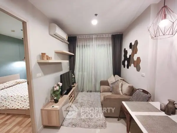 Modern living room with cozy sofa and stylish decor adjacent to bedroom