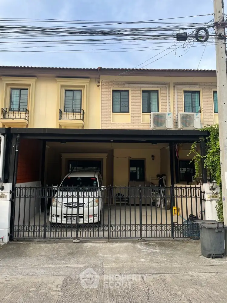 Charming townhouse with gated parking and modern facade in a peaceful neighborhood.