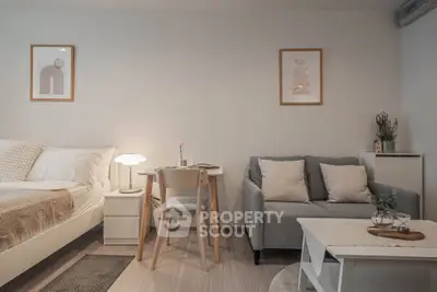 Cozy studio apartment with modern decor, featuring a comfortable bed, stylish sofa, and elegant dining area.
