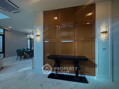 Luxurious modern interior with elegant dining area and stylish wooden paneling, perfect for sophisticated living.