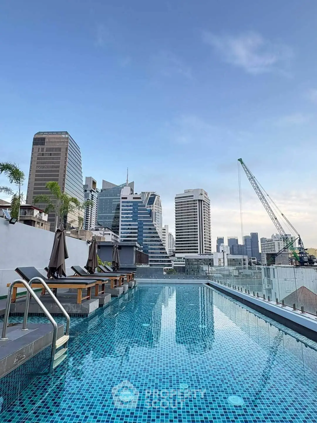 Stunning rooftop pool with city skyline views, perfect for urban living and relaxation.