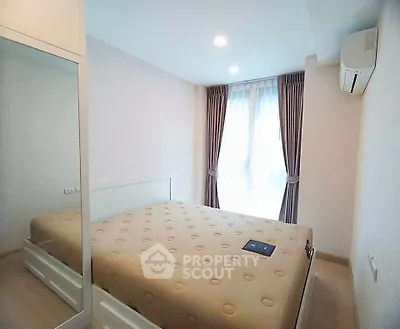 Bright and cozy bedroom with modern furnishings and ample natural light.