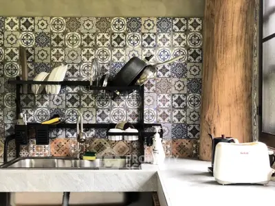Charming kitchen with rustic tile backsplash and modern appliances, perfect for culinary enthusiasts.