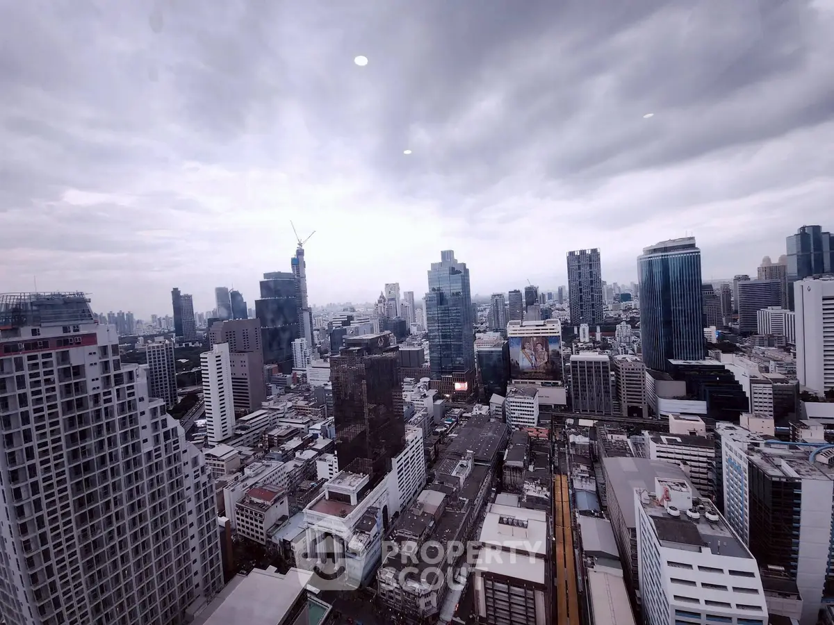 Stunning cityscape view from a high-rise building showcasing urban skyline and architectural diversity.