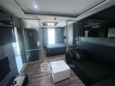 Modern bedroom with sleek black decor and glass partitions in a stylish apartment.