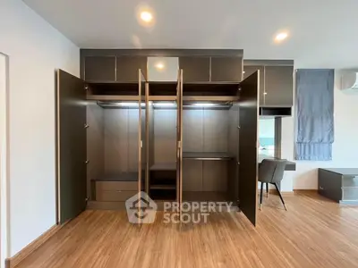 Spacious modern wardrobe with open doors in stylish apartment interior