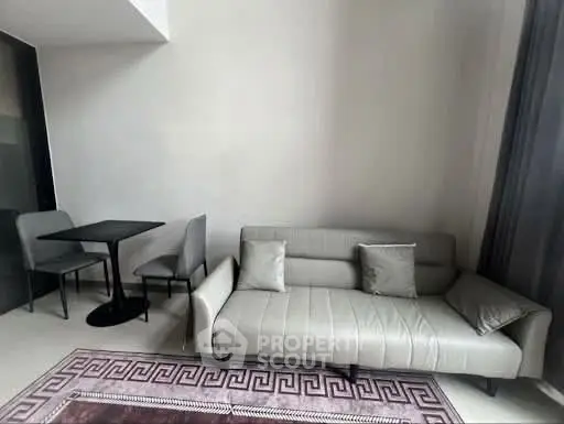 Modern living room with sleek sofa and dining area in stylish apartment