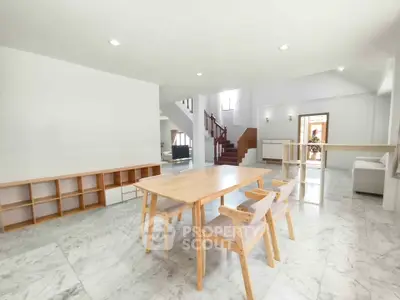 Spacious modern living room with marble flooring and elegant wooden furniture