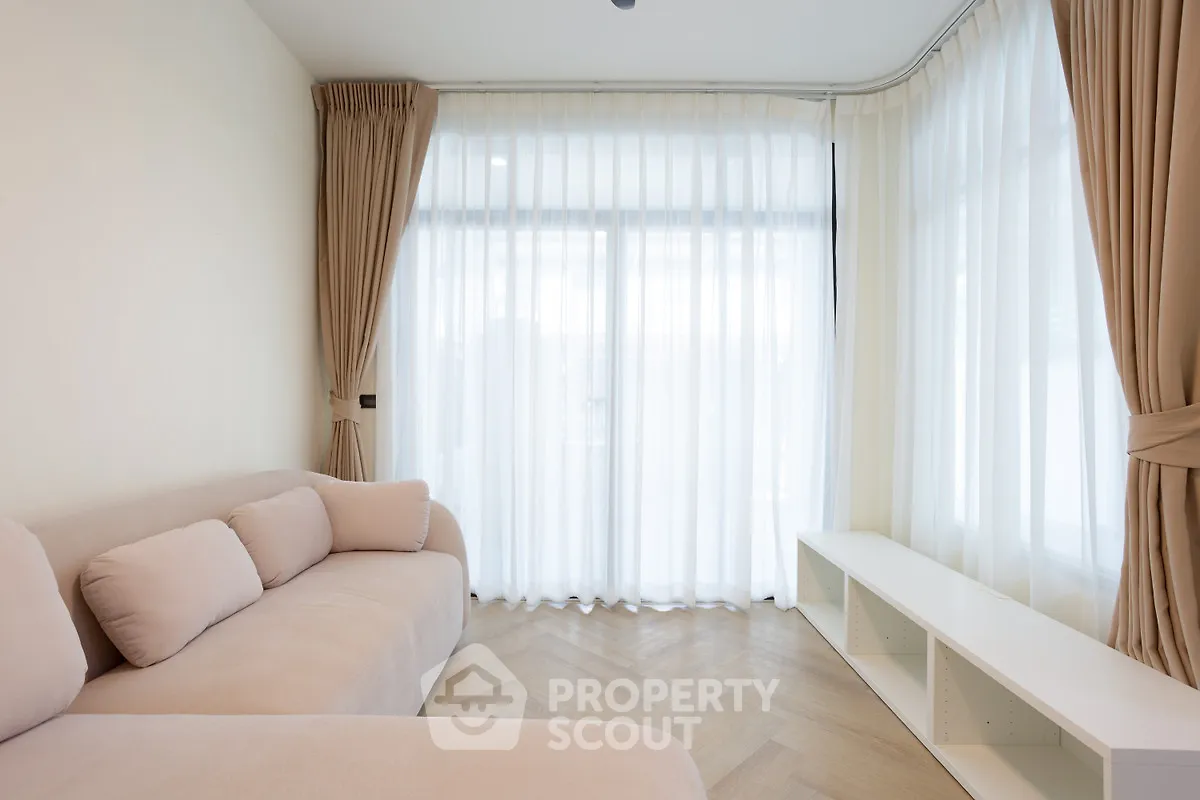 Bright and spacious living room with elegant curtains and modern furniture