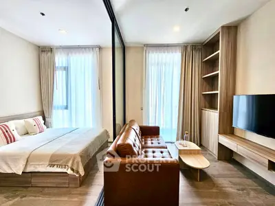 Modern studio apartment with cozy living area and stylish decor