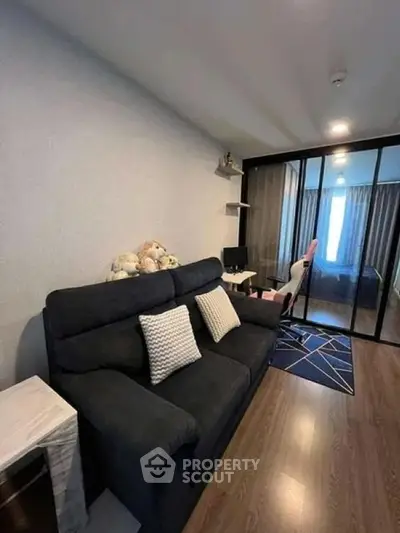 Modern living room with glass partition and cozy seating area
