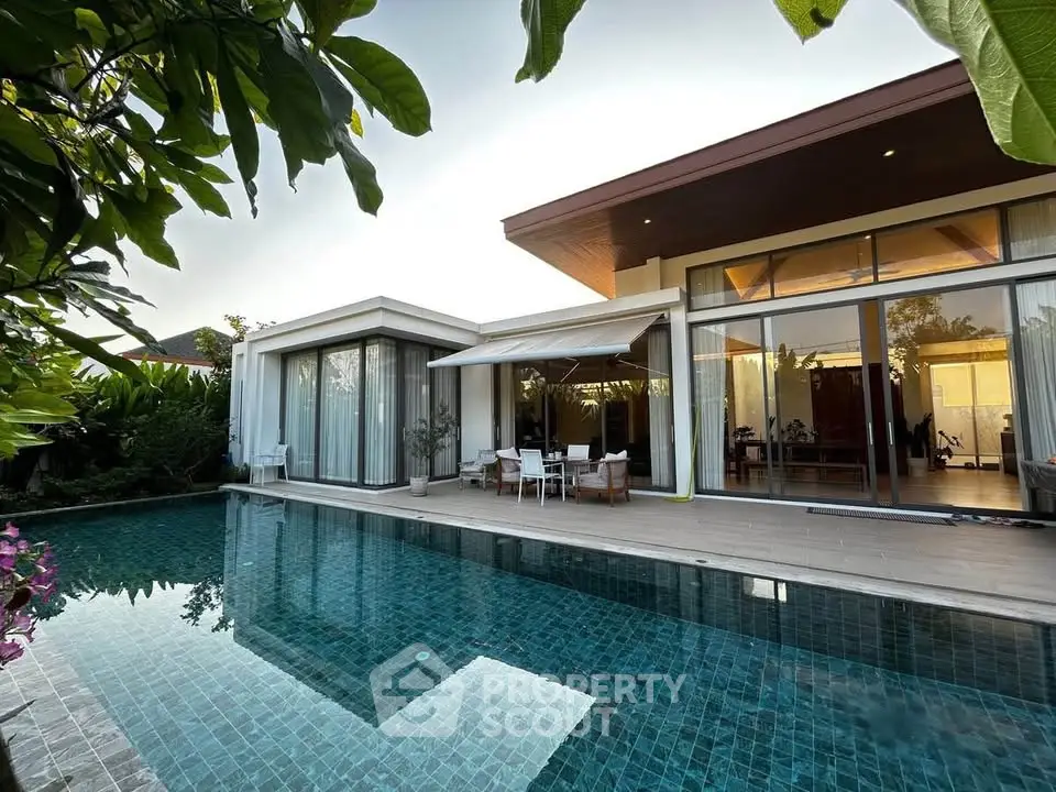 Luxurious modern villa with private pool and elegant outdoor seating area, perfect for relaxation.