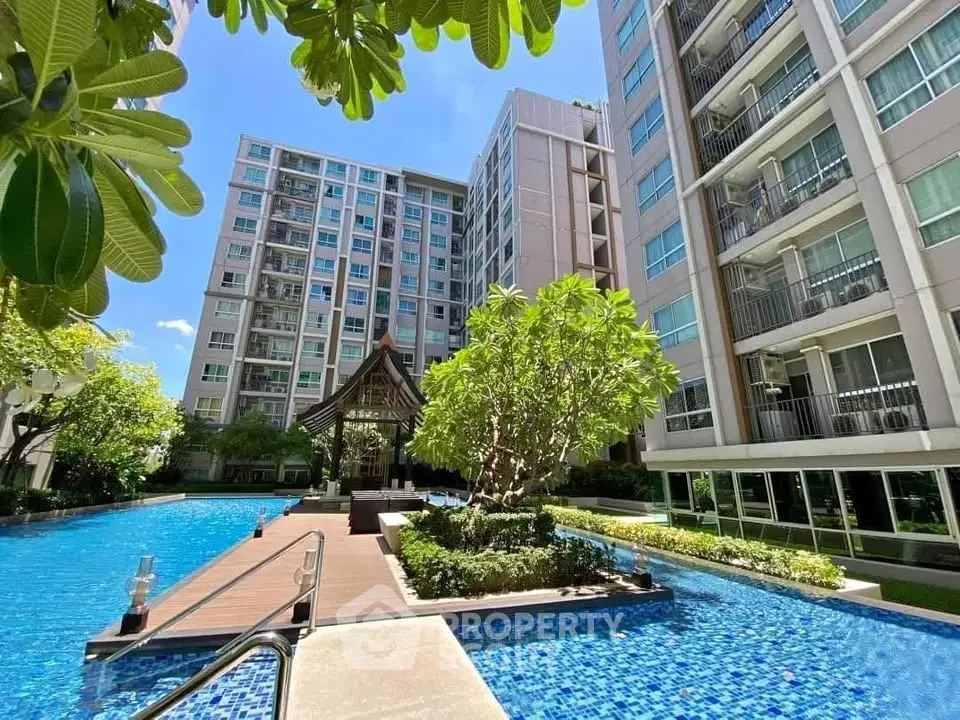Luxurious condominium with stunning pool and lush garden view
