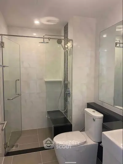 Modern bathroom with glass shower enclosure and sleek fixtures