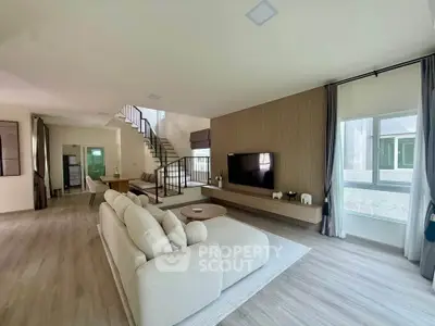 Spacious modern living room with elegant decor and large windows