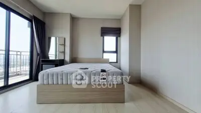 Spacious bedroom with large windows and balcony access, offering stunning views and natural light.