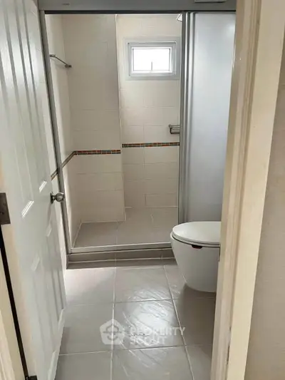 Modern bathroom with sleek shower and compact design, perfect for urban living.